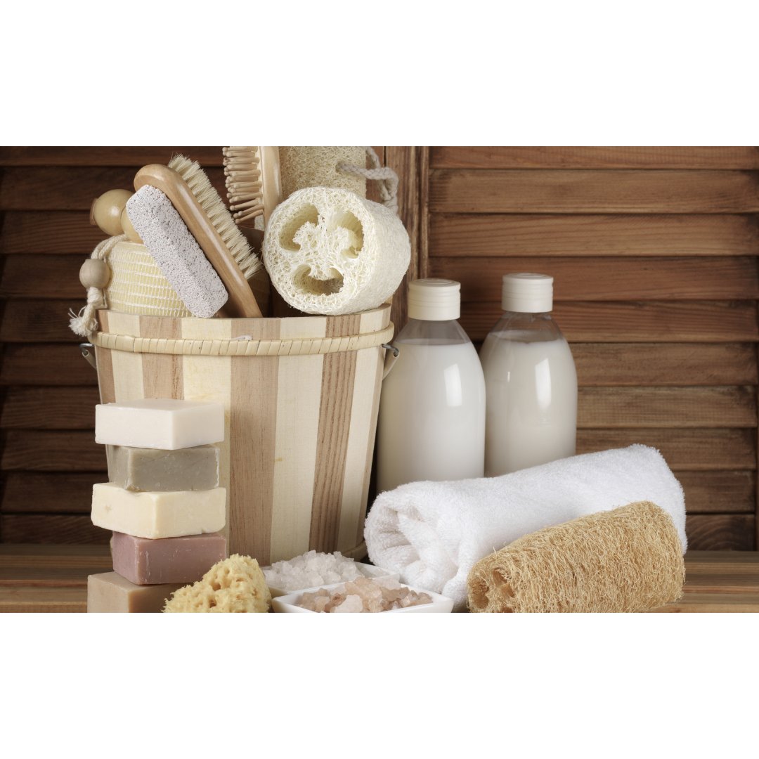 Celtic Clan Soapery Bath and Shower products. Neutral colors whites and tans soaps and loofas and bottles of body wash